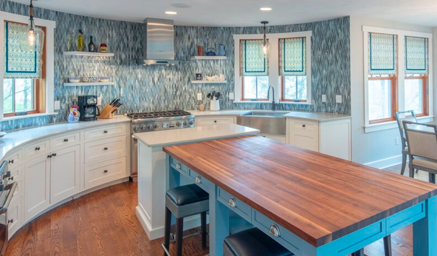 curved kitchen with blue island