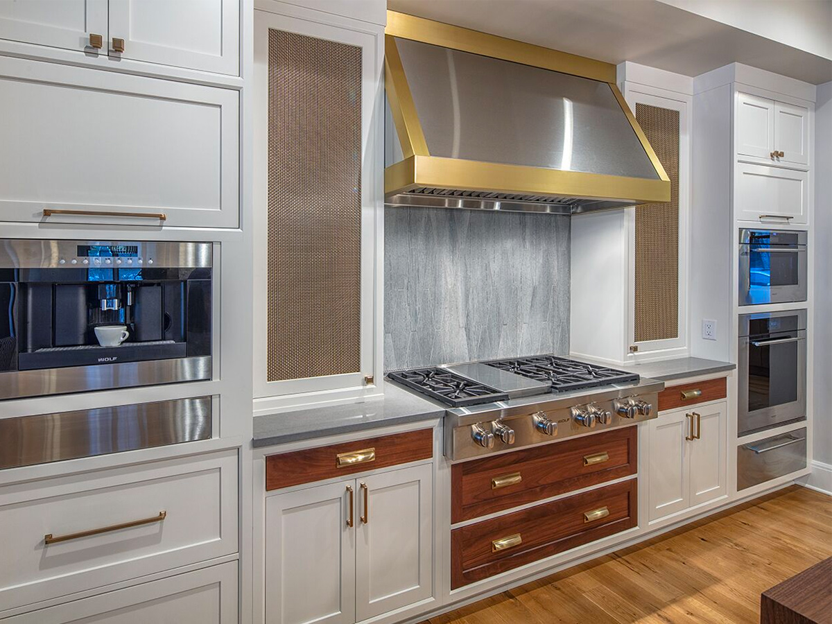 kitchen with oven & brass trimmed hood