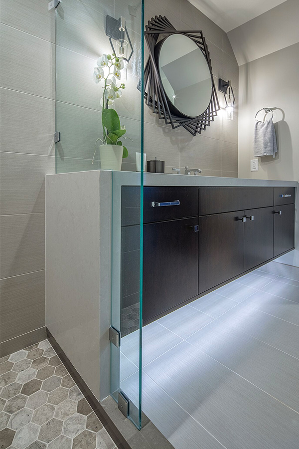 Bathroom with under-lit vanity and geometric mirror